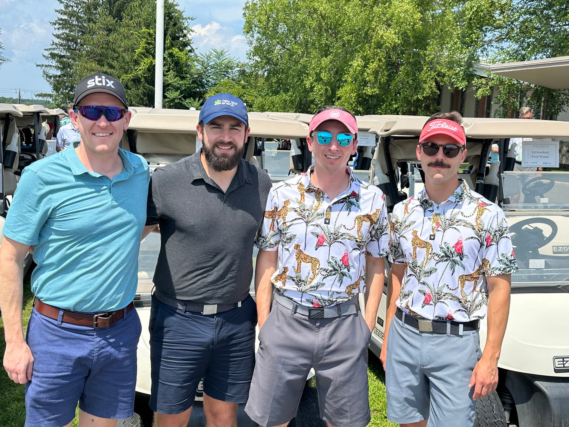 Four brothers in front of the golf carts at Crestview Country Club